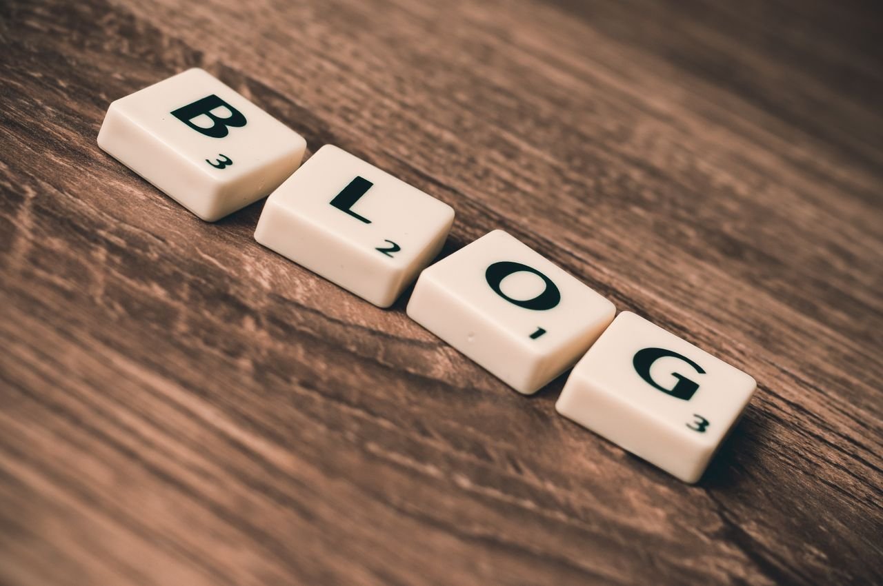 Scrabble tiles spelling the word blog on a wooden desk
